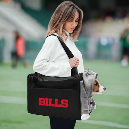 Woman carrying a dog in the Buffalo Bills pet carrier on a football field