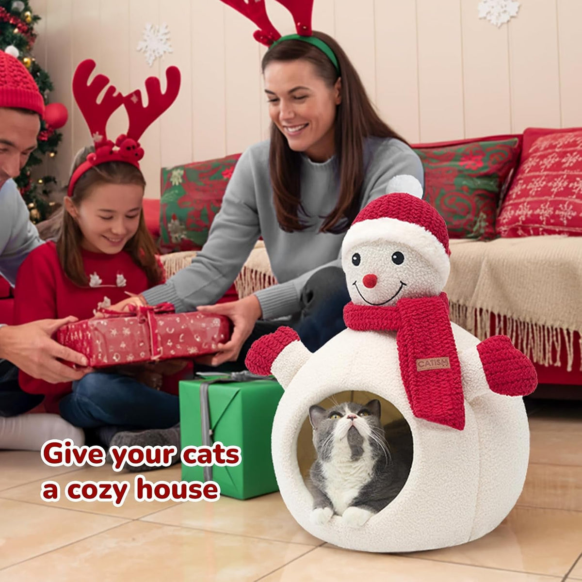 Family with a cat in the snowman bed by the Christmas tree